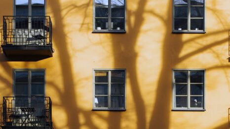 Yellow building with windows and balconies