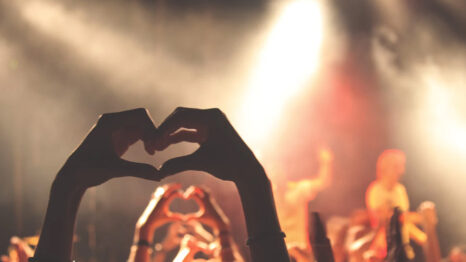 Concert goers making hearts with their hands